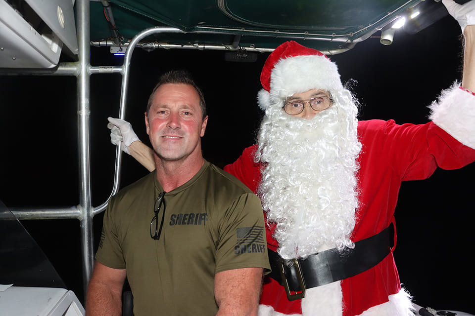 LABELLE -- Santa appreciates and thanks Lt. Rowe of the Hendry County Sheriff's Department for leading the Seoncnd annual Christmas Boat Parade. The support the Sheriff's Department provides to the parade is instrumental in its success! [Photo courtesy of Mike Eaton]
